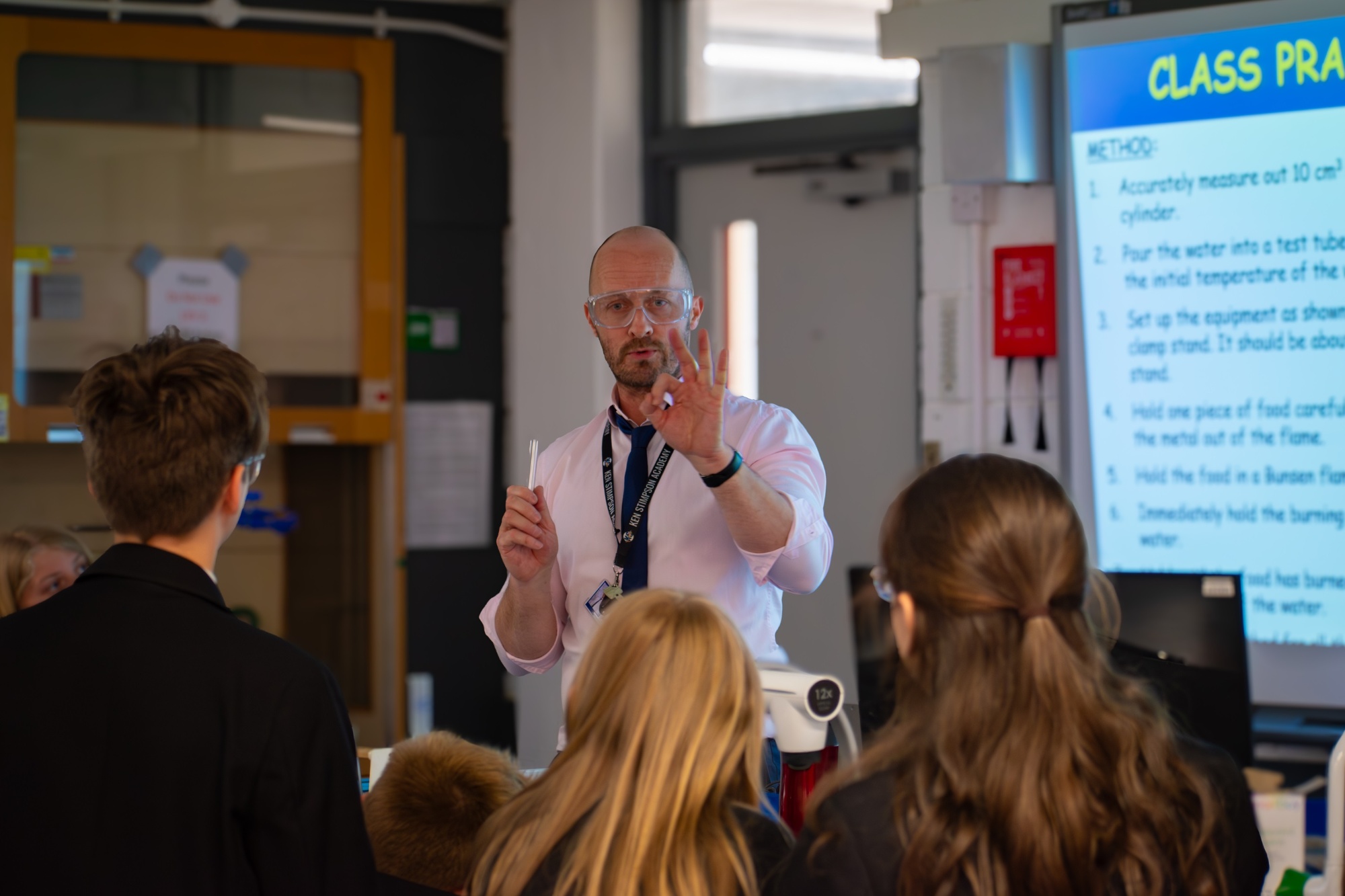 Teacher in classroom teaching students